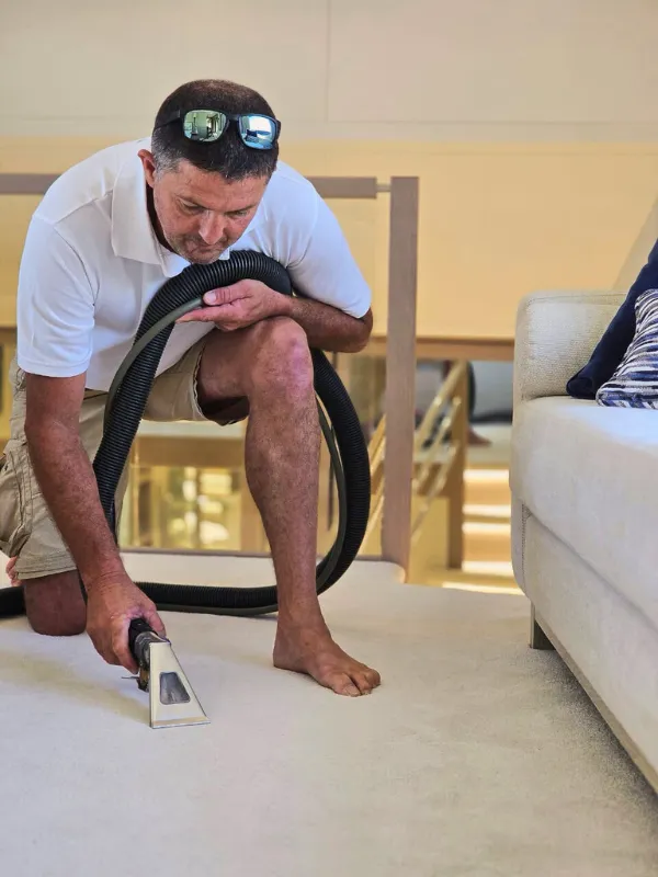 A Carpet care technician cleaning the carpet on a client's yacht